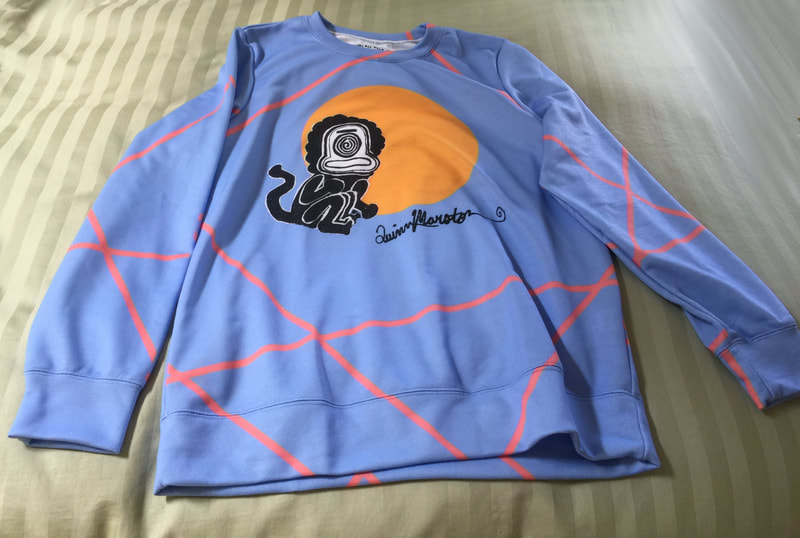 Blue and orange graphic sweatshirt with funny little sun monkey imagery from painting by Quinn Marston. Artist signature on front. For sale.